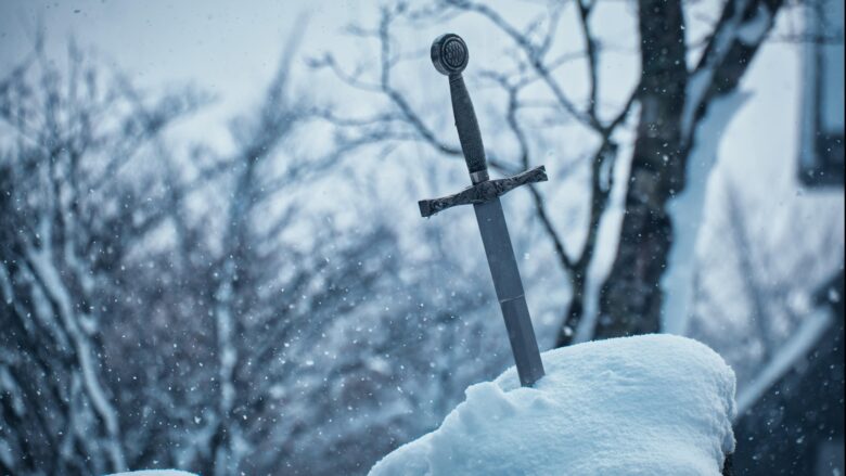 A photograph of a sword stuck in a snowbank. This is the featured image on a an article about creating better adventurers for Dungeons and Dragons.