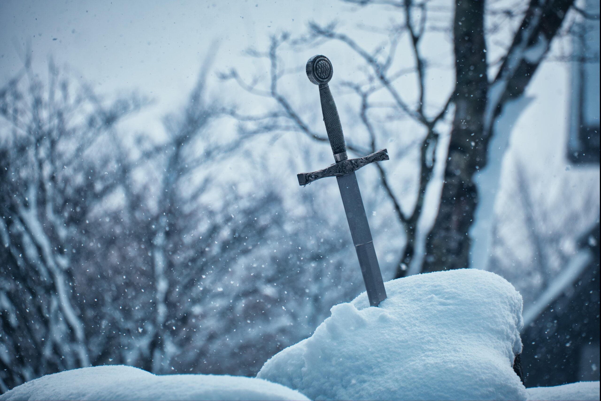 A photograph of a sword stuck in a snowbank. This is the featured image on a an article about creating better adventurers for Dungeons and Dragons.