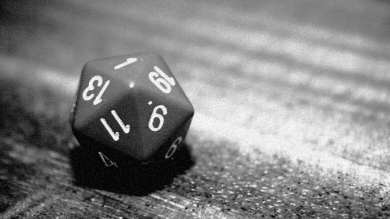 A black and white photo of a d20 on a table, with a 1 facing up. The image accompanies an article about the author's critical fumble as a DM.