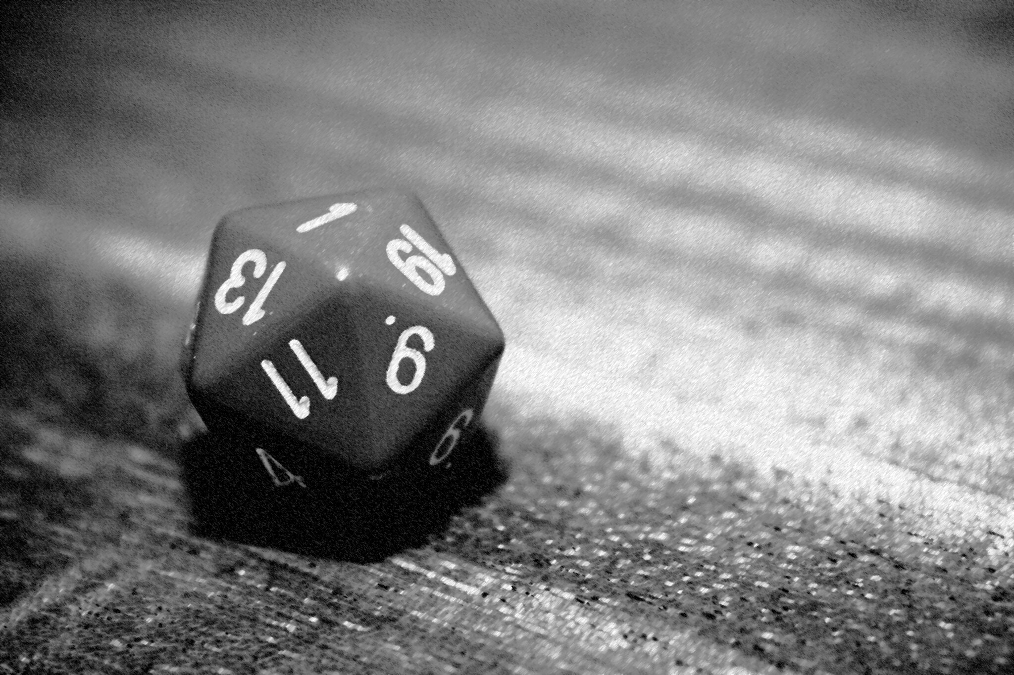 A black and white photo of a d20 on a table, with a 1 facing up. The image accompanies an article about the author's critical fumble as a DM.