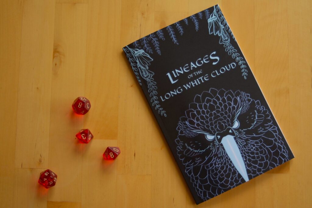 A photo of a physical copy of Lineages of the Long White Cloud by Kelly Whyte lying on a table next to some TTRPG dice. The book's cover shows line art of a native bird of New Zealand with some flowers and hanging ferns.